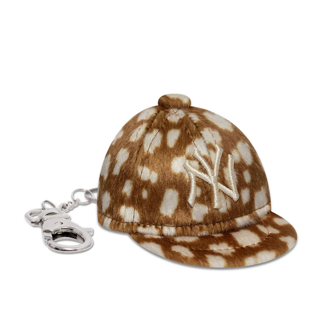 New Era New York Yankees MLB Animal Mini Cap Light Brown Key Chain, front view showing the white embroidered NY logo on the front panel, a brown spotted pattern covering the entire structured mini cap, and a silver keychain attachment on the side.