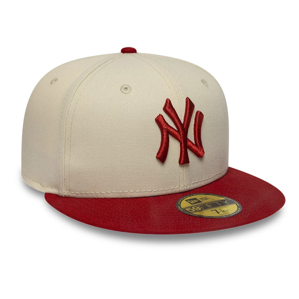 New York Yankees MLB League Essential Cream & Red New Era 59FIFTY Fitted Cap, three-quarter view showing raised red embroidered NY logo on the cream front panel, paired with a contrasting red flat visor and gold 59FIFTY size sticker.