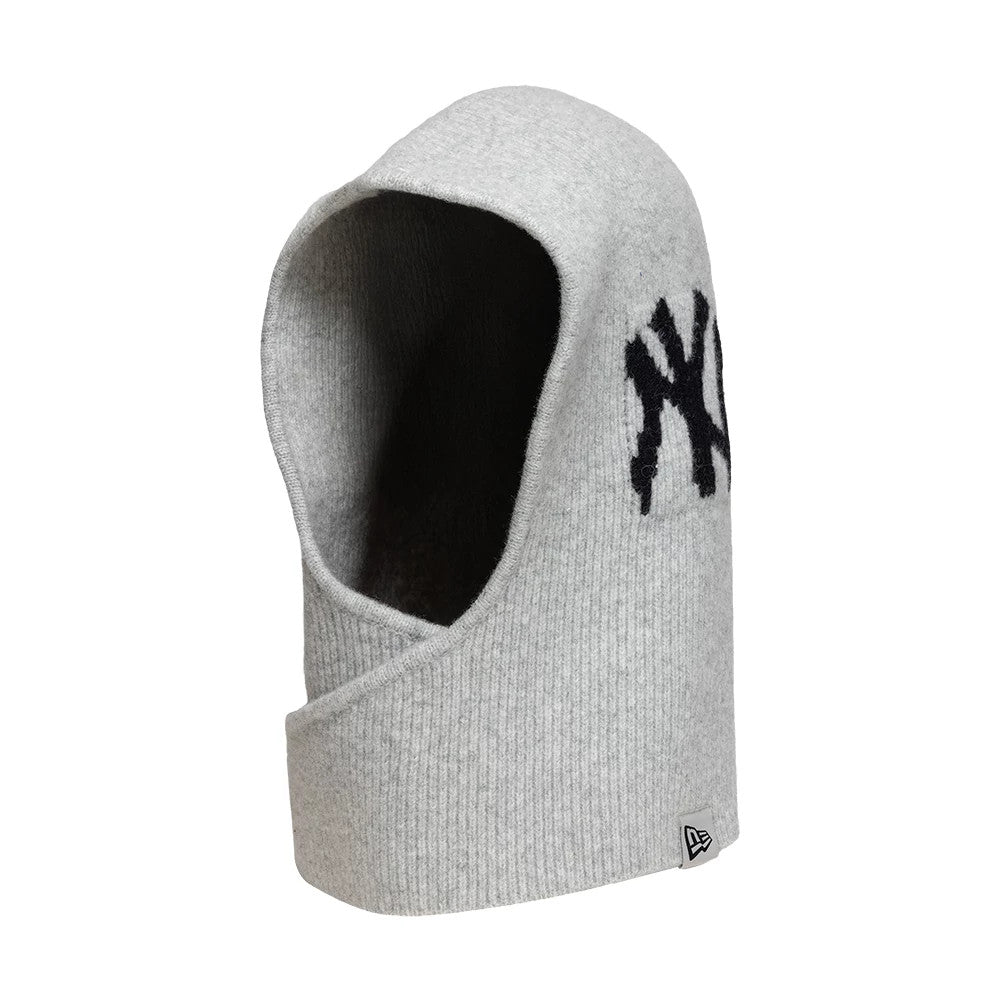 New Era New York Yankees Womens MLB Knitted Grey Balaclava Hat, side view showing the black embroidered NY logo on the upper side, a soft grey ribbed texture with an opening for the face, and the New Era flag logo on the lower edge.