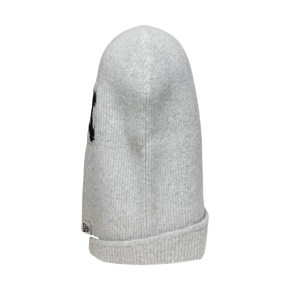 New Era New York Yankees Womens MLB Knitted Grey Balaclava Hat, side view showing the soft ribbed grey knit texture, large black embroidered NY logo partially on the side, and folded edge with a small New Era flag logo tag.