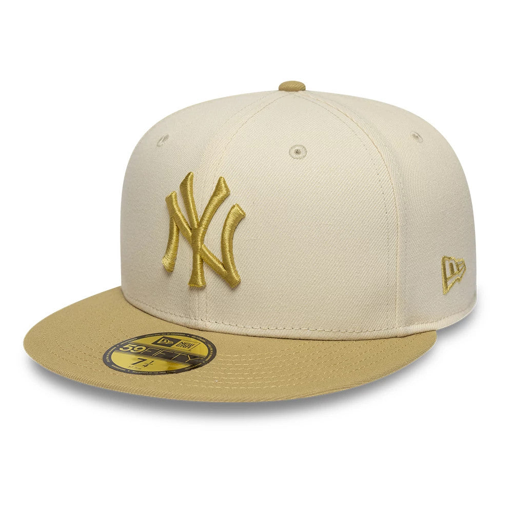 New York Yankees MLB League Essential Cream & Gold New Era 59FIFTY Fitted Cap, front view with raised gold embroidered NY logo on the cream front panel, a contrasting gold visor, and a gold 59FIFTY size sticker on the visor.