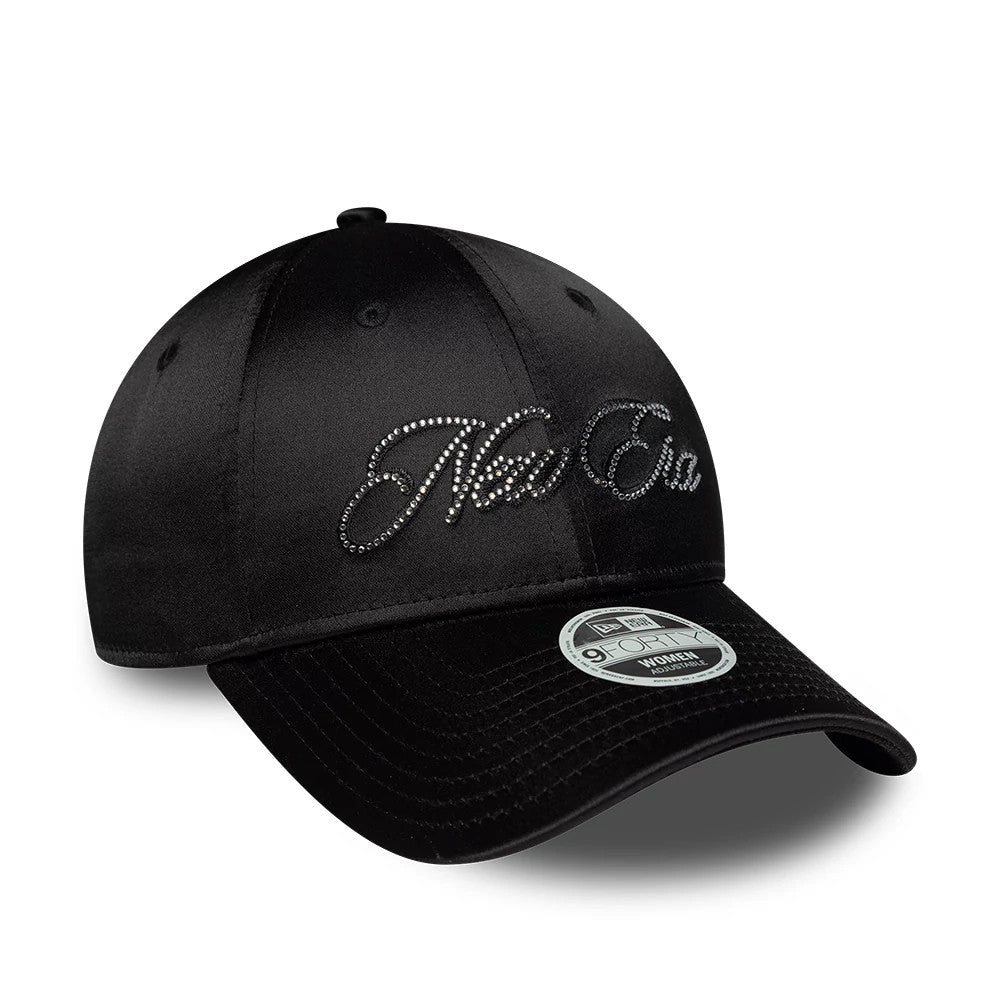 Womens New Era Satin Gem Black 9FORTY Adjustable Cap, three-quarter view showing the black rhinestone New Era script logo on the front panel, black curved visor with a 9FORTY size sticker, and eyelets on the structured crown.
