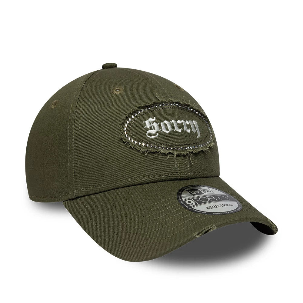 New Era Gem Patch Distress Green 9FORTY Adjustable Cap, front view showing a distressed embroidered Sorry patch with gem accents on the front panel, a curved visor with a 9FORTY size sticker, and olive green structured crown.