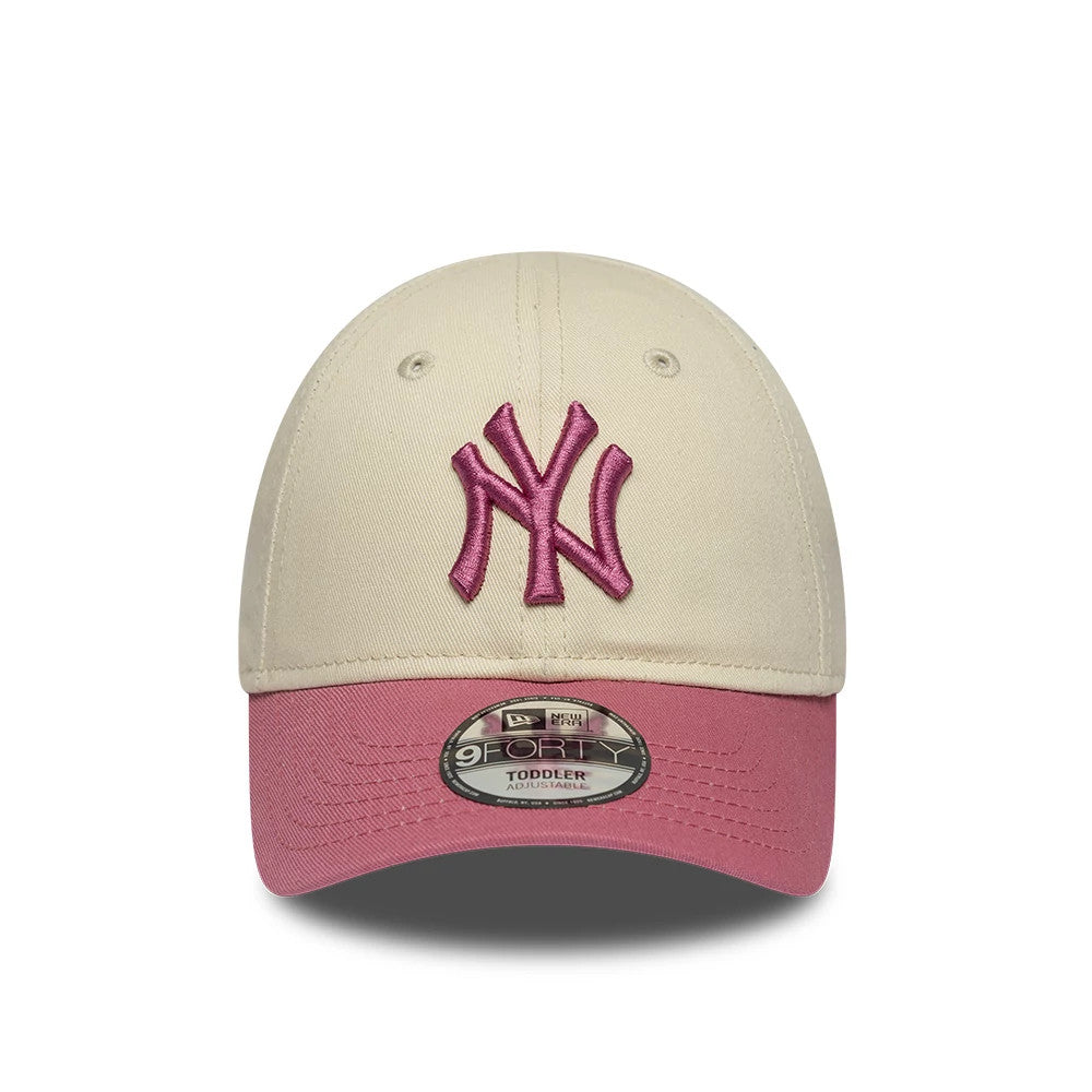 Yankees Toddler MLB League Essential Light Beige New Era 9FORTY Adjustable Cap, front view showing a pink embroidered Yankees logo on the structured beige crown, pink curved visor, and 9FORTY size sticker on the visor.