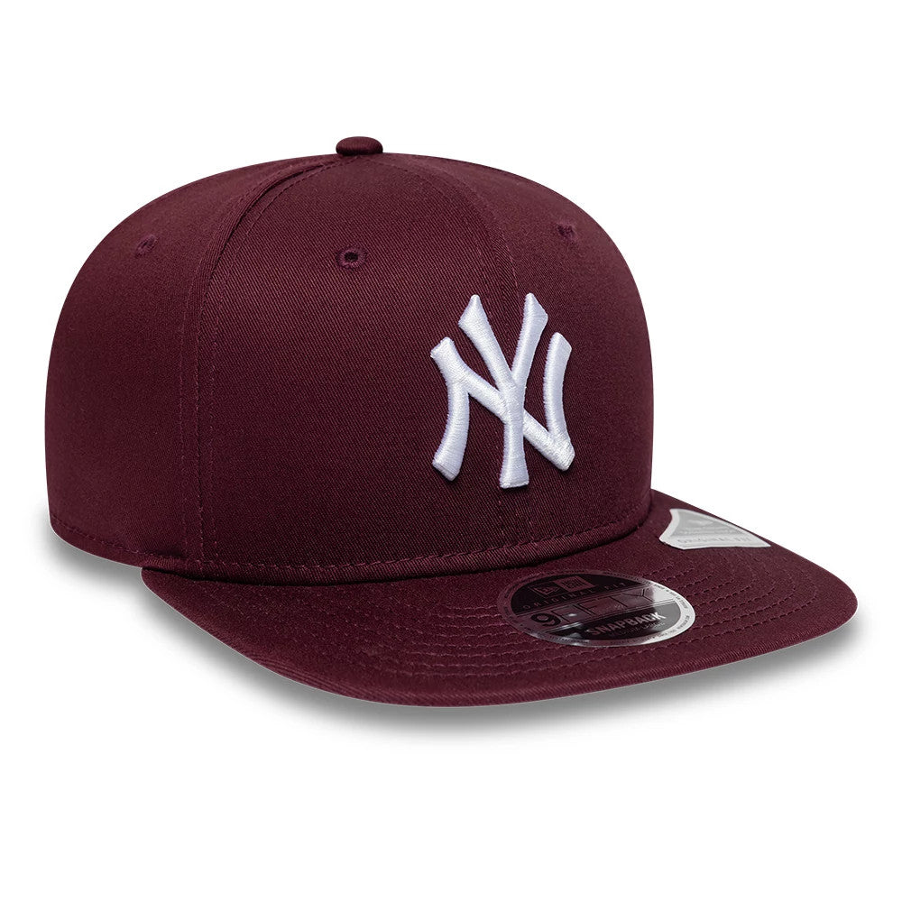Yankees MLB League Essential Purple New Era 9FIFTY Original Fit Snapback Adjustable Cap, three-quarter view showing the raised white NY logo embroidered on the front panel, with a flat purple visor and a 9FIFTY size sticker on the visor.
