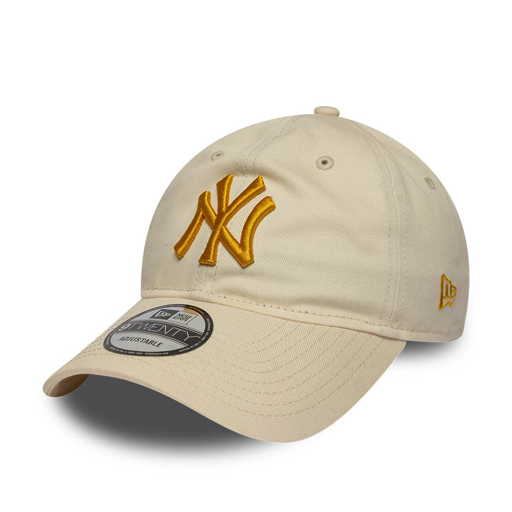 New York Yankees MLB League Essential Light Beige New Era 9TWENTY Adjustable Cap, front three-quarter view showing the raised gold embroidered NY logo on the front panel, curved visor with a 9TWENTY size sticker.