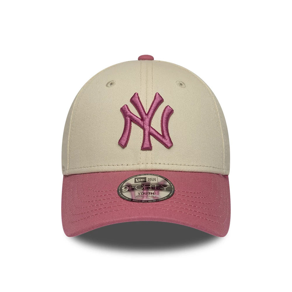 Yankees Youth MLB League Essential Light Beige & Pink New Era 9FORTY Adjustable Cap, front view showing a pink embroidered interlocking NY logo on the light beige front panel, a contrasting pink visor, and a 9FORTY size sticker on the visor.