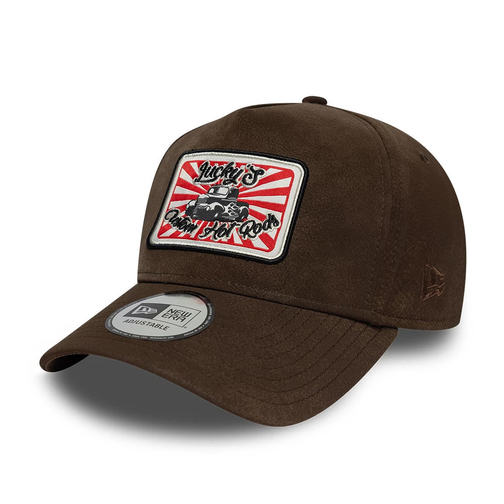 New Era Moto Patch PU Brown 9FORTY E-Frame Adjustable Cap, three-quarter view showing a patch with a vintage car and red sunburst design on the front panel, brown structured crown, and New Era flag logo embroidered on the left side.