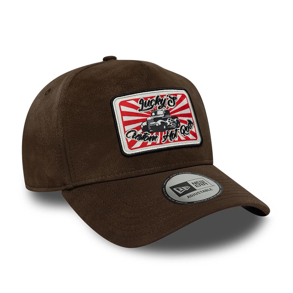 New Era Moto Patch PU Brown 9FORTY E-Frame Adjustable Cap, three-quarter view showing a rectangular embroidered patch with a custom hot rod design on the front panel, brown structured crown, and a 9FORTY size sticker on the curved visor.