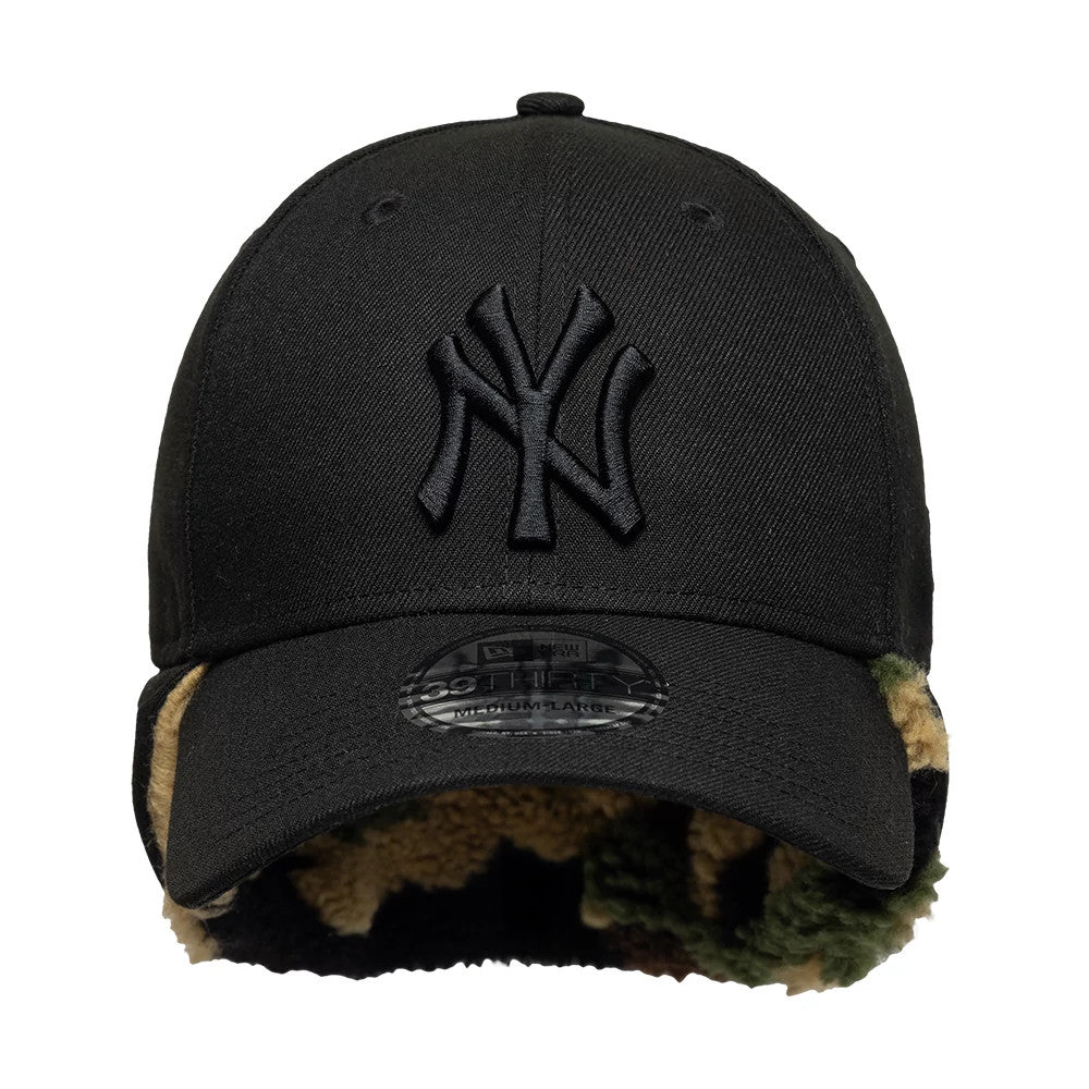New York Yankees MLB Black New Era 39THIRTY Downflap Stretch Fit Cap, front view showing the black raised embroidered NY logo on the crown, the camo-pattern downflap peeking out from under the black curved visor.