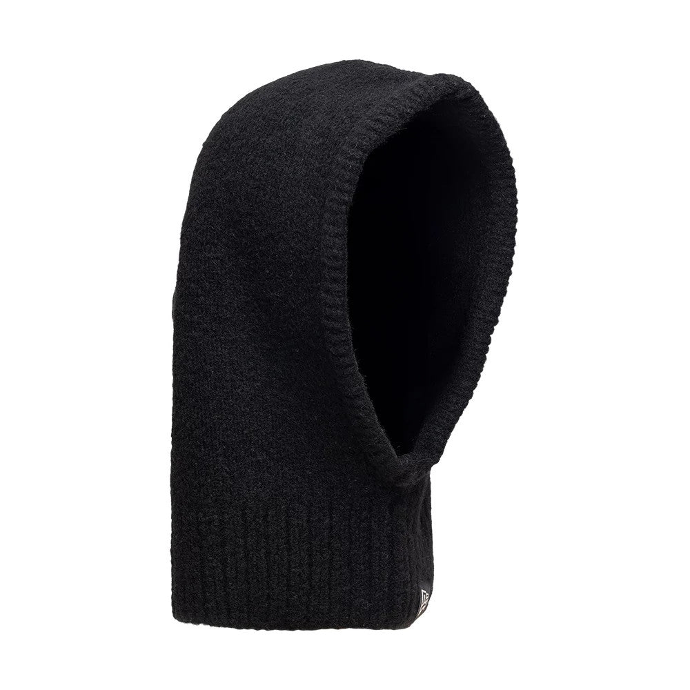 New Era Slouch Black Balaclava Hat, side view showing the deep, rounded hood shape with an extended neck section, crafted from soft black fabric and featuring a ribbed hem with the New Era flag logo embroidered near the edge.