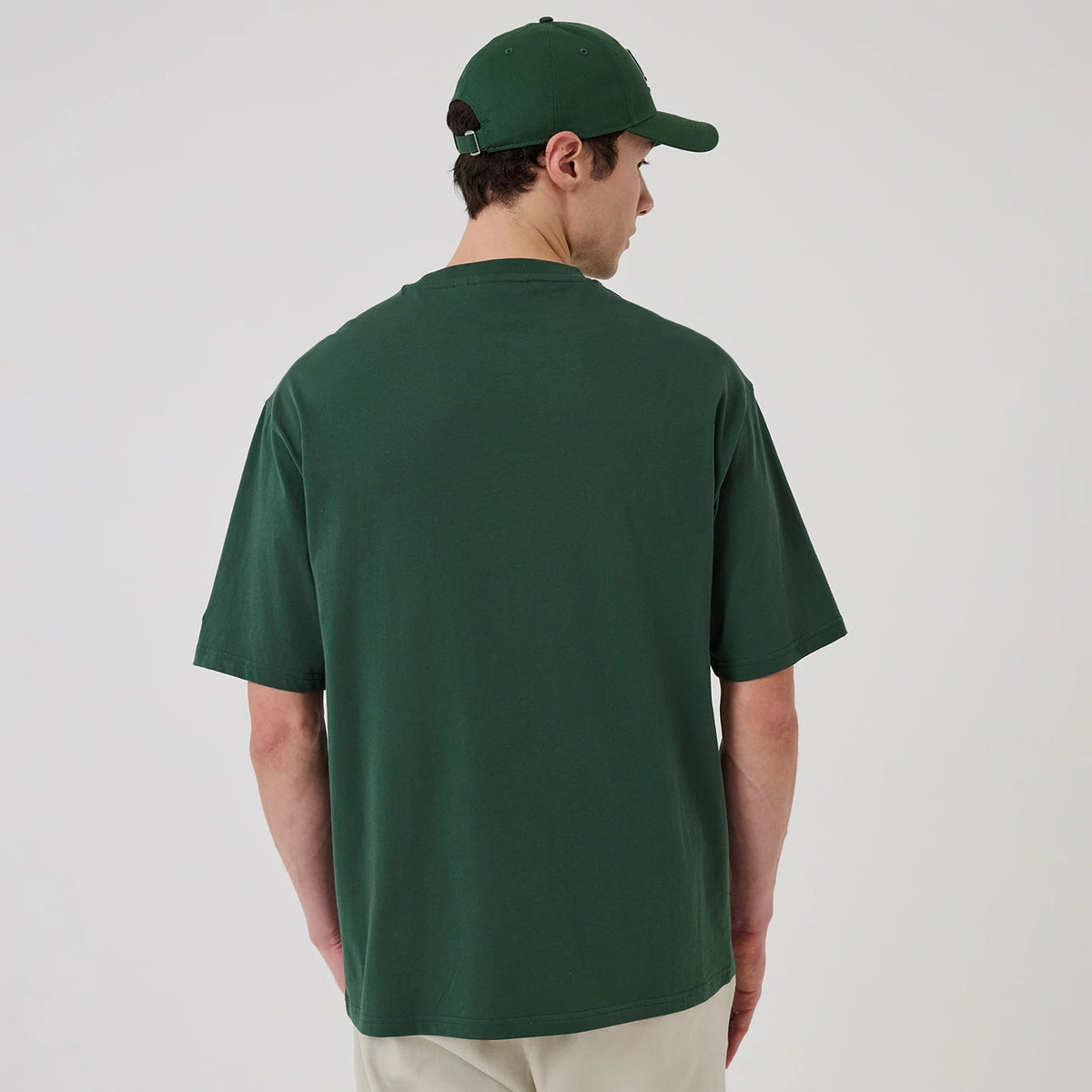 The model is wearing this MLB Food Graphic LA Dodgers Oversized T-Shirt in dark green. 2
