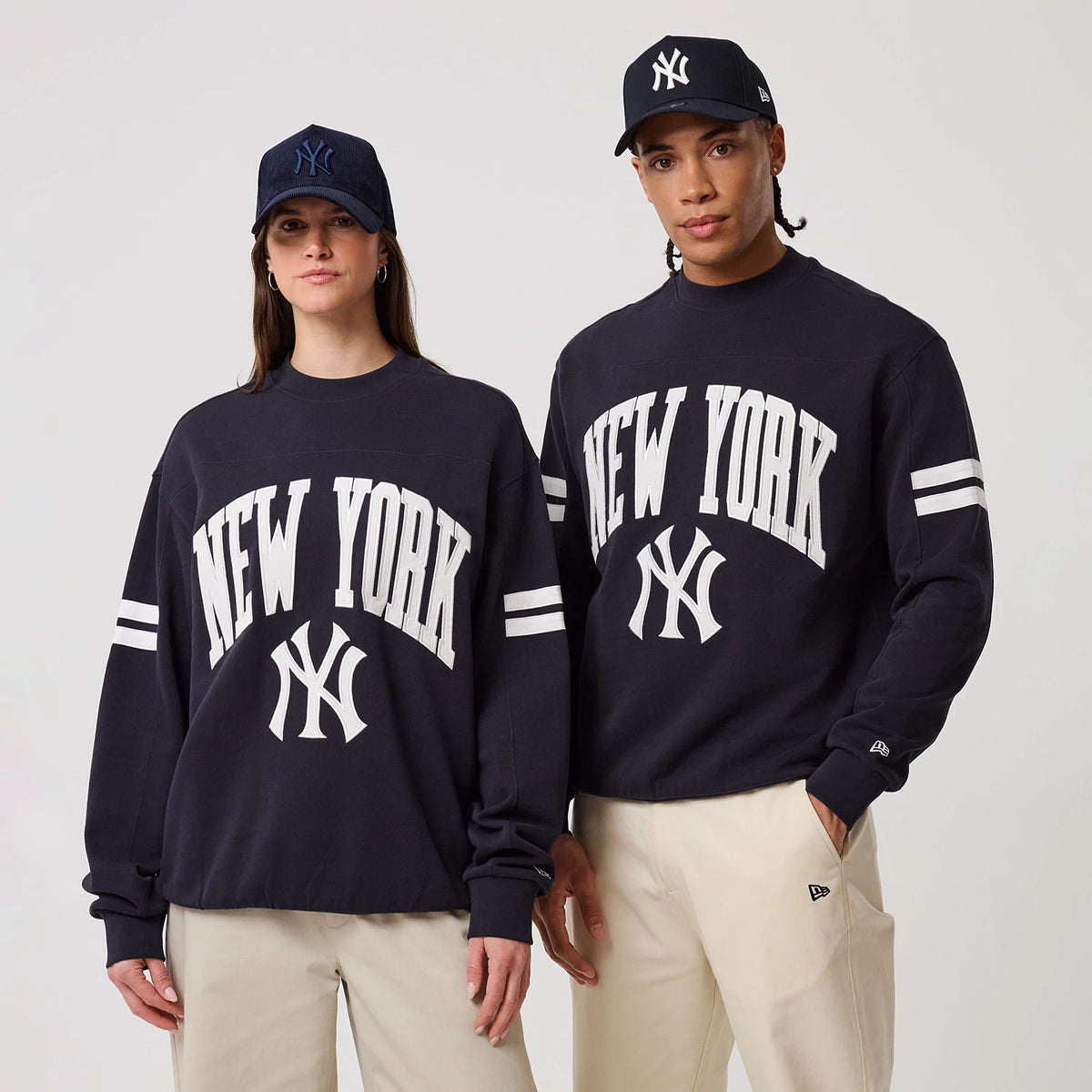 The model is wearing this MLB Arch Graphic New York Yankees Crew Neck Sweater in navy. 1