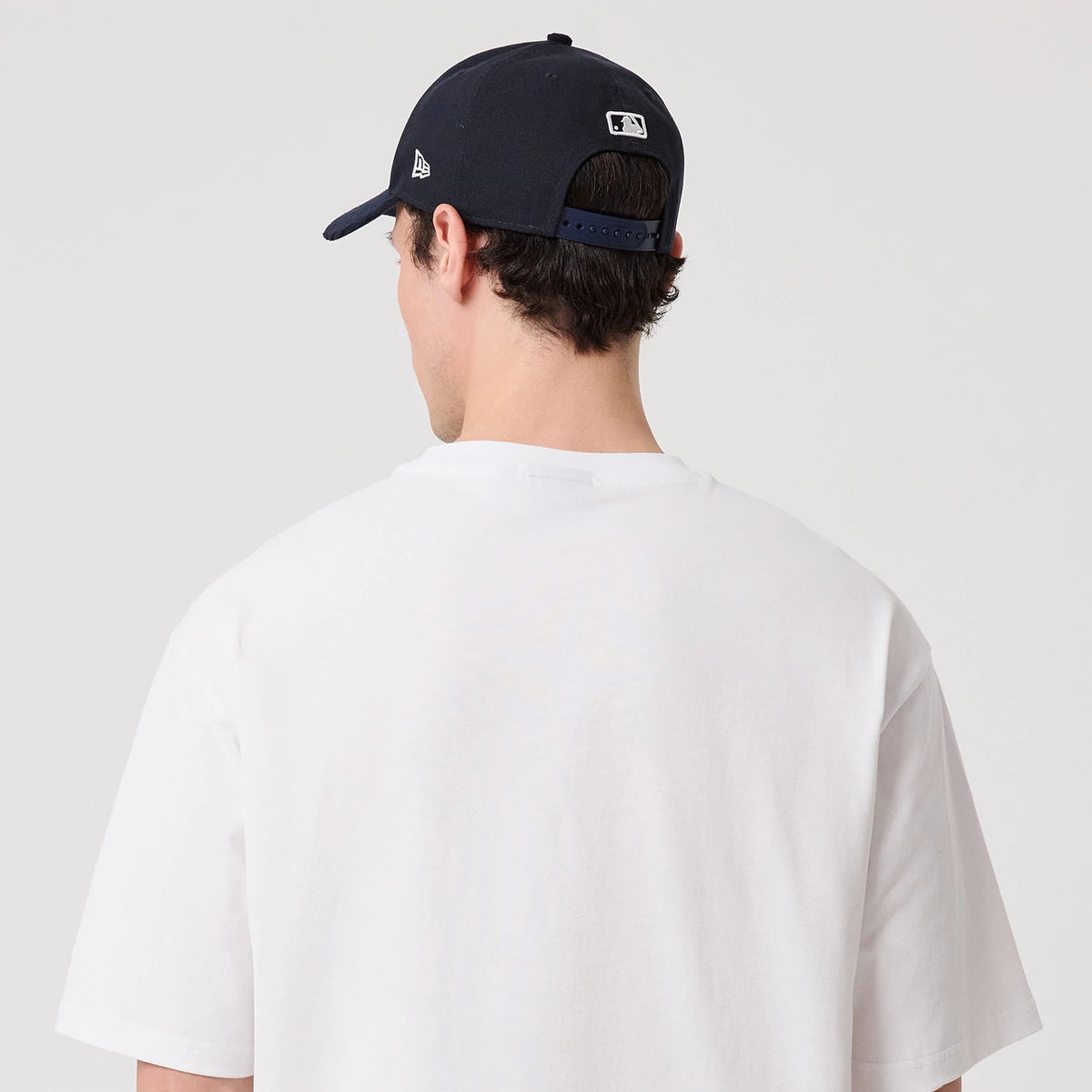 The model is wearing this New Era Heritage Oversized T-Shirt in white. 8