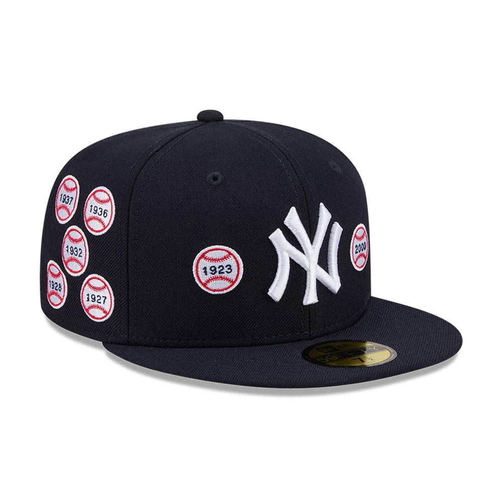 New York Yankees MLB X Spike Lee Patches Navy New Era 59FIFTY Fitted Cap, three-quarter view showing the raised white NY logo on the front panels, several embroidered baseball patch designs and the gold 59FIFTY size sticker on the flat navy visor.