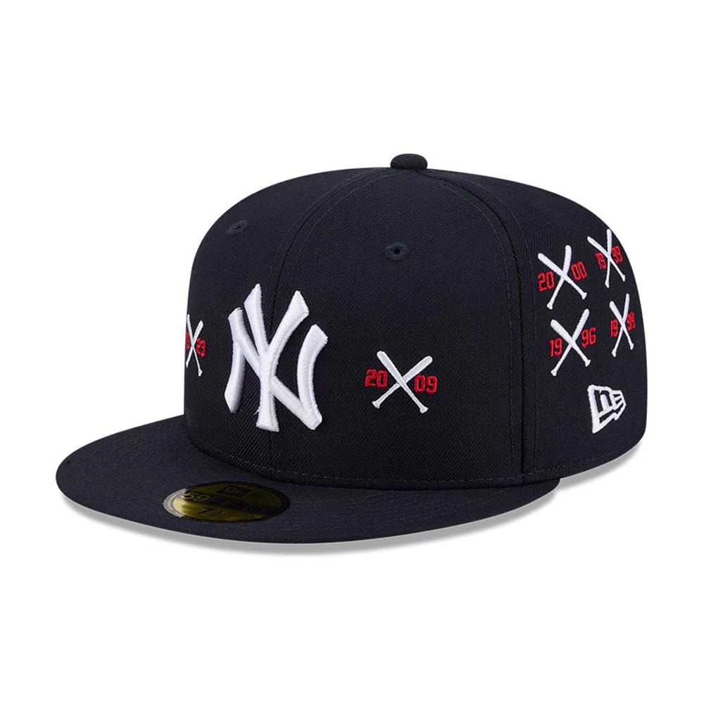 Yankees MLB X Spike Lee Crossed Bats Navy New Era 59FIFTY Fitted Cap, three-quarter view showing raised white NY logo on the front panel, red and white crossed bats graphics with years on the side, and a gold 59FIFTY size sticker on the visor.