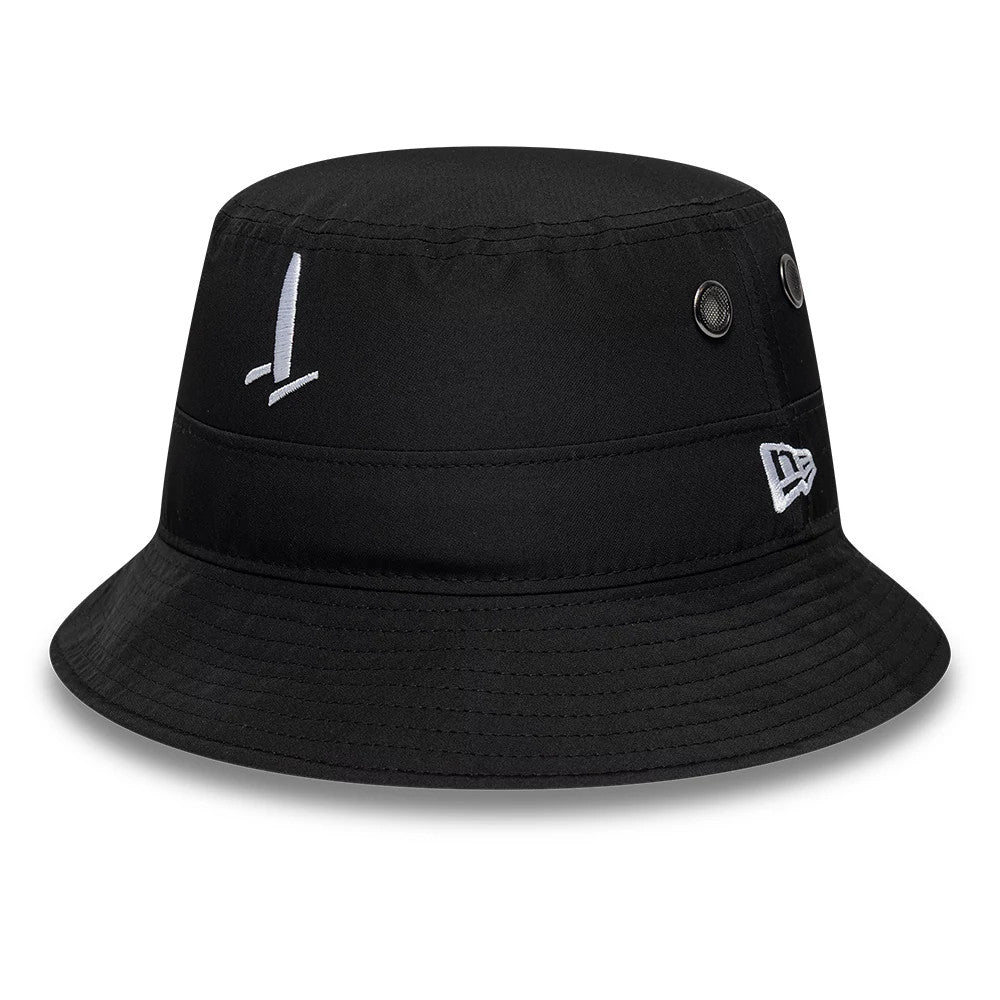New Era Sail GP Catamaran Black Adventure Bucket Cap, three-quarter view showing a white embroidered sail graphic on the front, round eyelets on the side for ventilation, and a white New Era flag logo embroidered on the side.