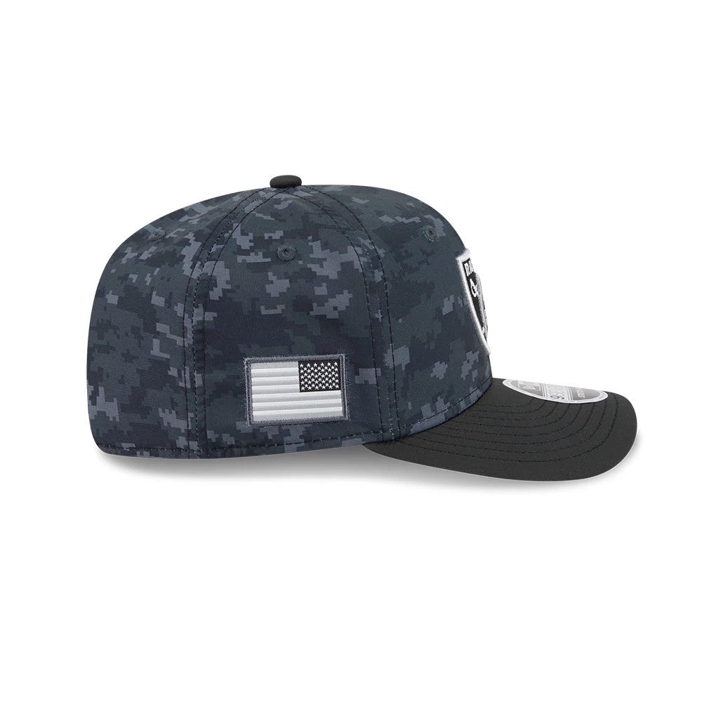 Raiders NFL Digi Camo & Black New Era 9SEVENTY Stretch Snap Adjustable Cap, side view showing the black and grey digi camo pattern with an embroidered flag patch on the right side, a black structured visor and the front panel size sticker.