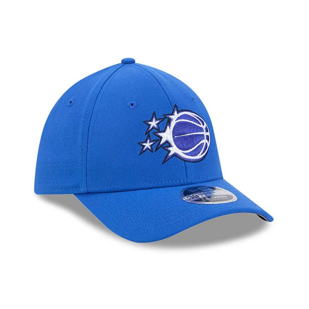 Orlando Magic NBA Team Blue New Era 39THIRTY M-Crown Stretch Fit Cap, front view showing the raised embroidered team logo in blue and white on the front panel, with a curved blue visor and a 39THIRTY size sticker.