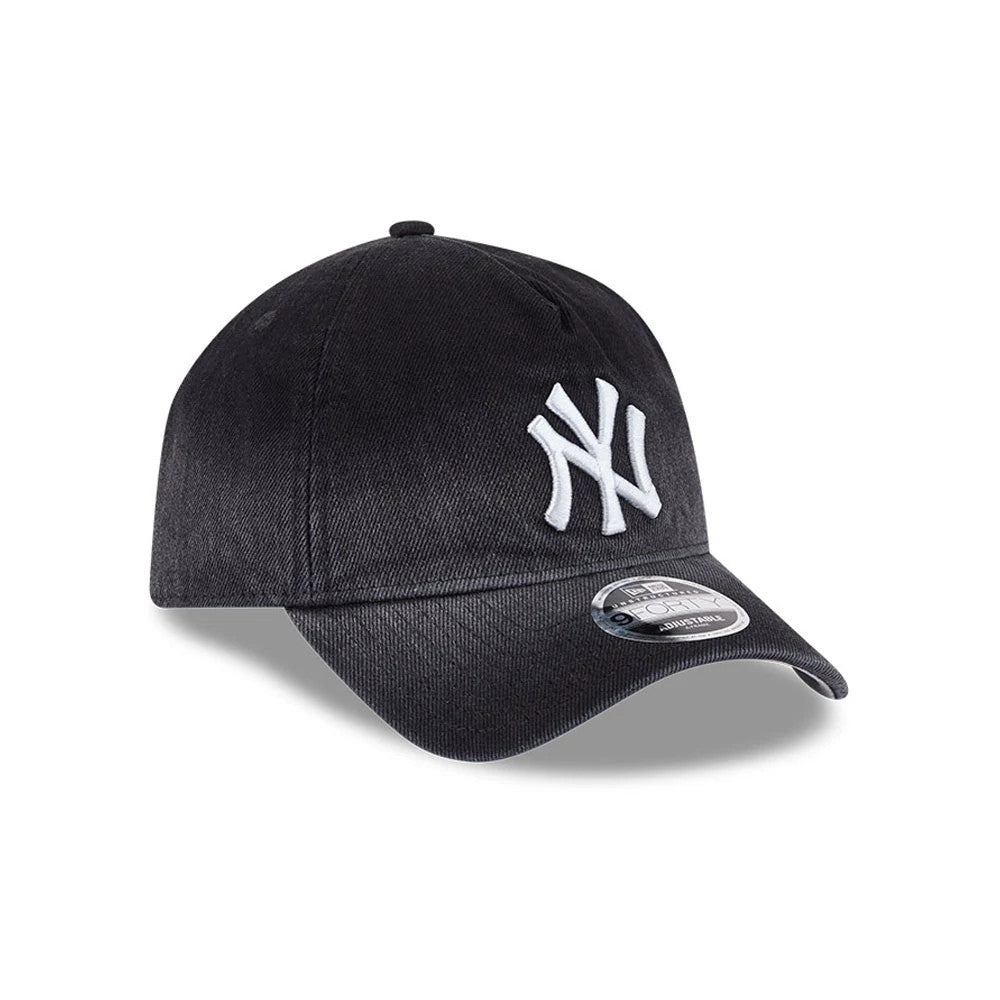 Yankees MLB Washed Denim Black New Era 9FORTY A-Frame Unstructured Adjustable Cap, three-quarter view showing a white embroidered NY logo on the front panel, a curved black visor, and the 9FORTY size sticker on the top of the visor.