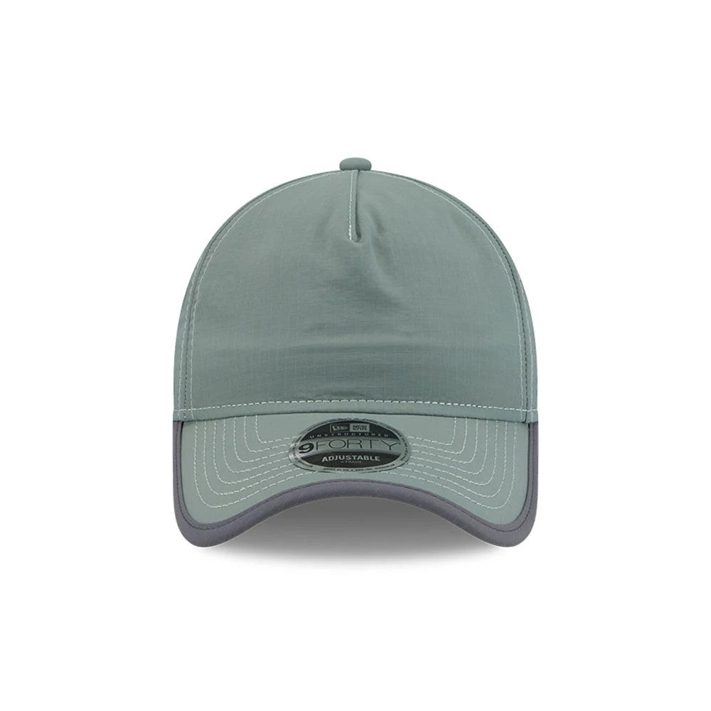 New Era Elevated Basics Open Green 9FORTY A-Frame Unstructured Adjustable Cap, front view showing a green front panel with prominent curved stitching, a dark grey visor, and a 9FORTY size sticker centred on the underside of the visor.