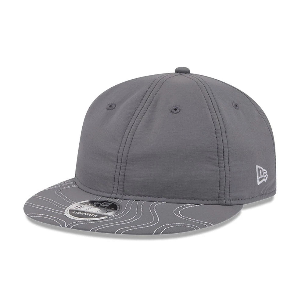 New Era Elevated Basics Open Grey Retro Crown 9FIFTY Adjustable Cap, three-quarter view showing the grey visor with white topographic line pattern, the New Era flag logo embroidered on the left side, and a 9FIFTY size sticker on the visor.