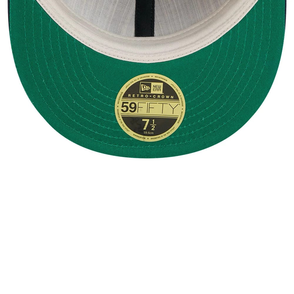 New York Yankees Fear Of God X MLB Navy Retro Crown New Era 59FIFTY Fitted Cap, inside view showing a green undervisor with a central gold 59FIFTY size sticker, white sweatband, and black taping running along the seam.