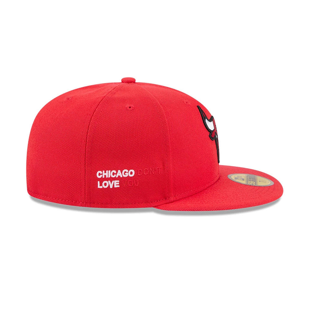 Chicago Bulls NBA X J-FROST Red New Era 59FIFTY Fitted Cap, side view showing the white embroidered Chicago Dont Love You text on the left panel, the black and red Bulls logo at the front, and a gold 59FIFTY size sticker on the flat visor.