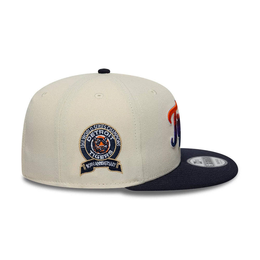 Tigers MLB Ombre Script Light Beige & Navy New Era 9FIFTY Snapback Adjustable Cap, side view showing the embroidered Detroit Tigers World Series Champions logo on the left side of the light beige crown, with a contrasting navy flat visor.