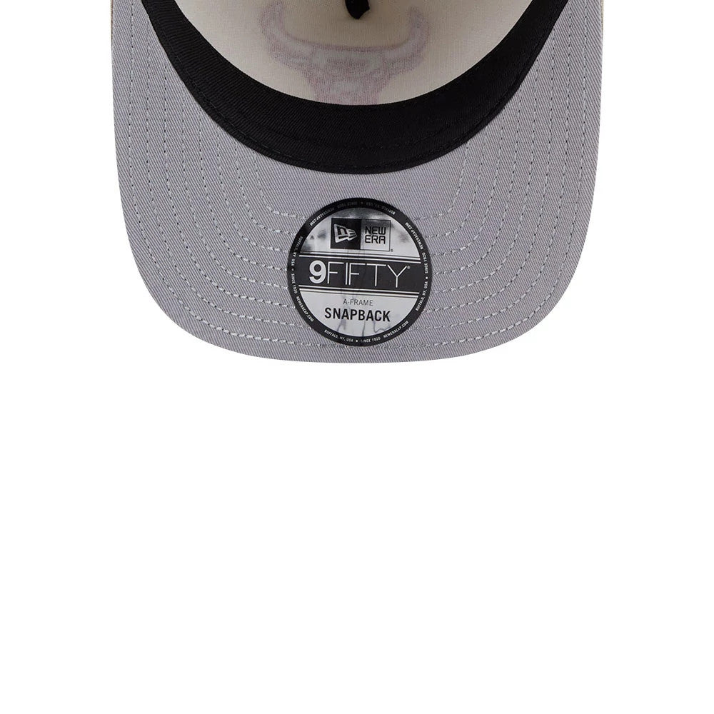 Chicago Bulls NBA Light Beige New Era 9FIFTY A-Frame Snapback Adjustable Cap, inside view showing the black 9FIFTY size sticker on the grey visor, with the faint outline of the Bulls logo on the light beige undervisor.