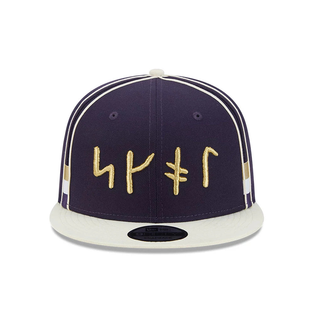 Vikings NFL Rivalry 2026 Dark Purple New Era 9FIFTY Snapback Adjustable Cap, front view showing flat gold embroidered symbols on the structured dark purple crown, complemented by a pale visor and 9FIFTY size sticker on the visor.