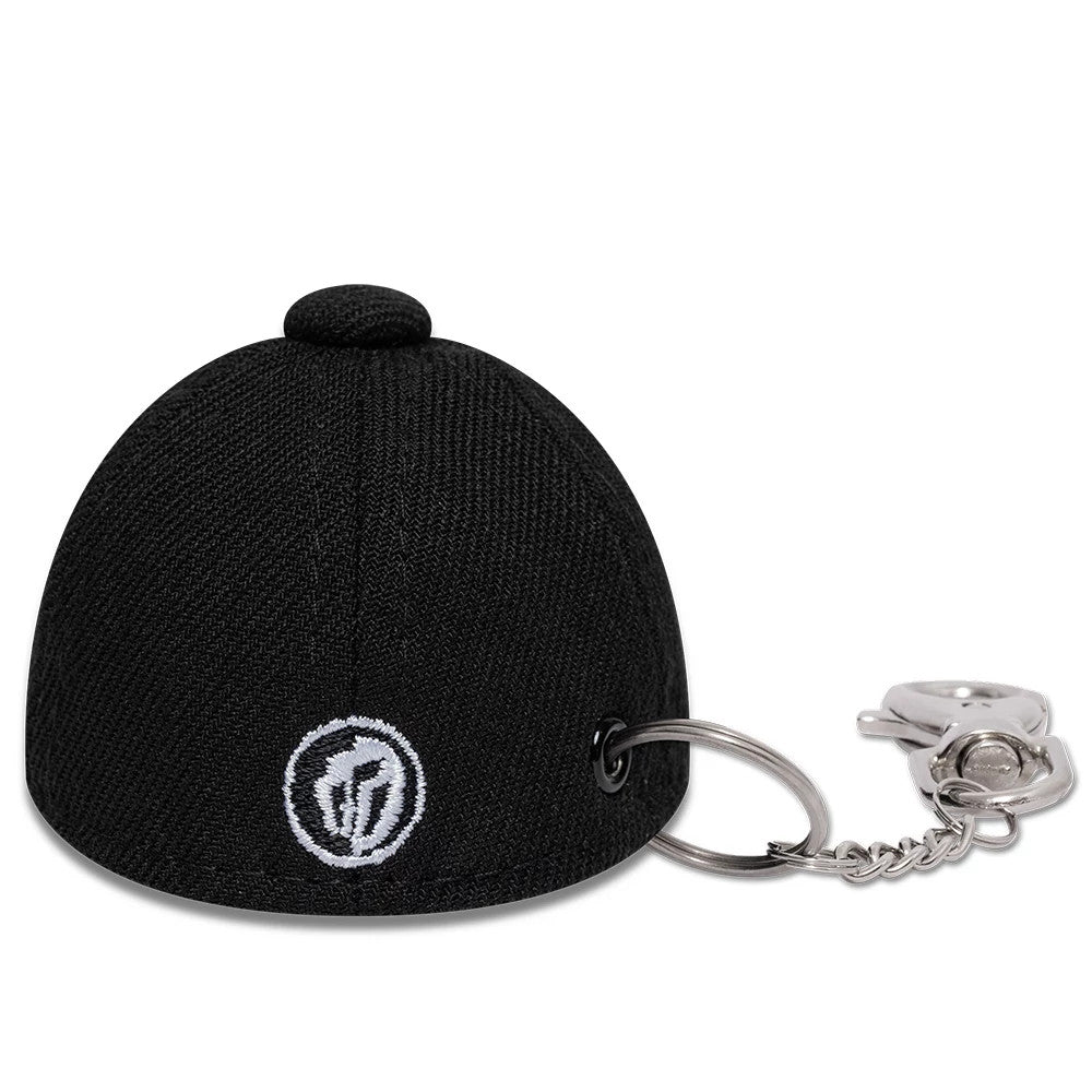 Gettomasa X New Era Black Key Chain, rear view showing a miniature black cap design, featuring a small white embroidered logo on the back, with a keyring attached through an eyelet on the structured black crown.
