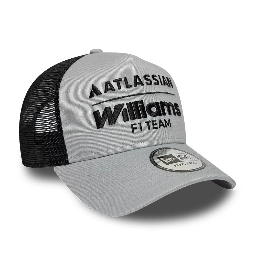 Williams E-Frame Grey New Era 9FORTY A-Frame Trucker Adjustable Cap, three-quarter view showing black embroidered Atlassian and Williams F1 Team logos on the grey front panel, black mesh rear panels.