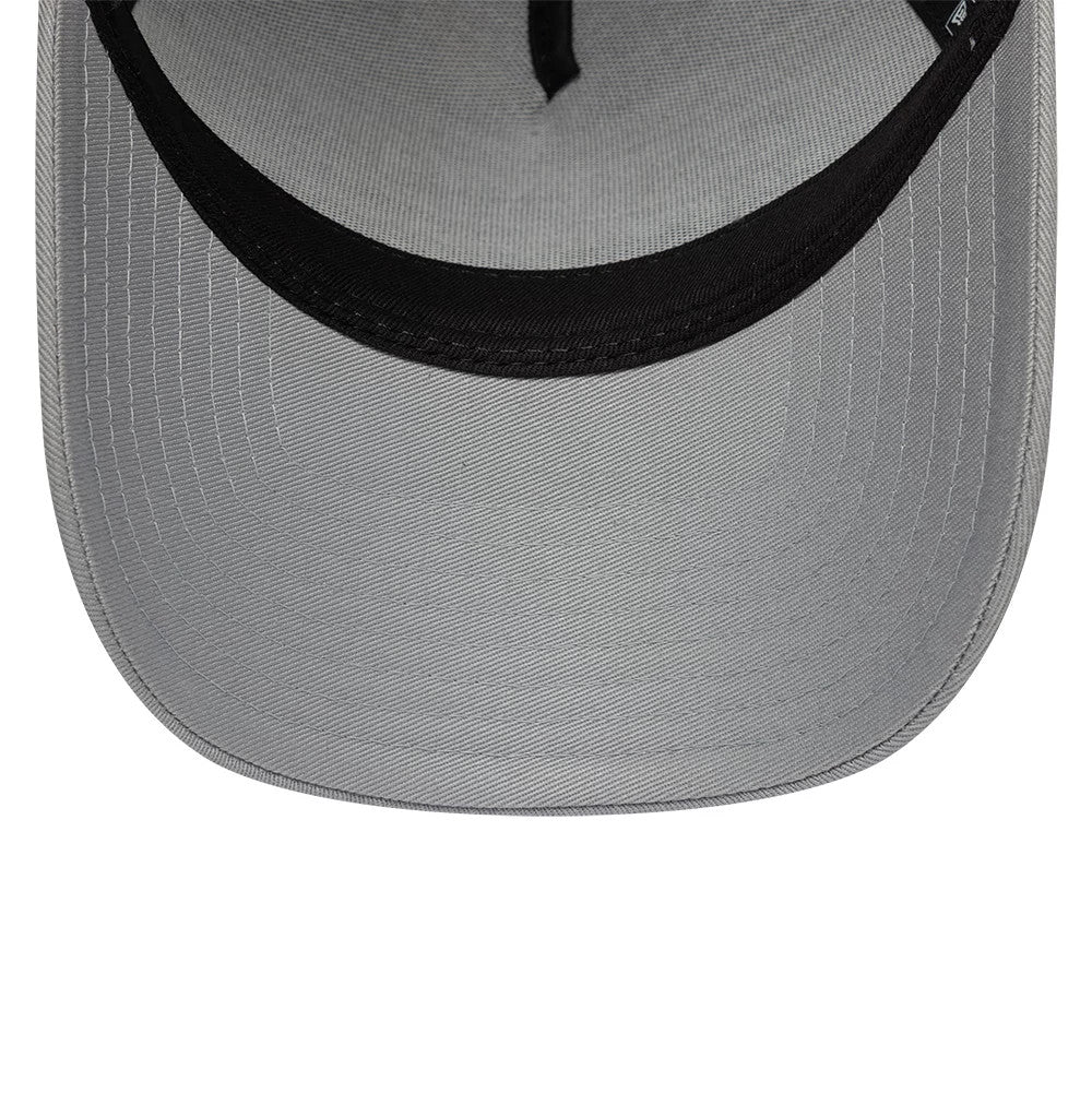 Williams E-Frame Grey New Era 9FORTY A-Frame Trucker Adjustable Cap, inside view showing the grey undervisor with neat stitching, a black sweatband running along the edge, and part of the New Era flag logo on the taping.