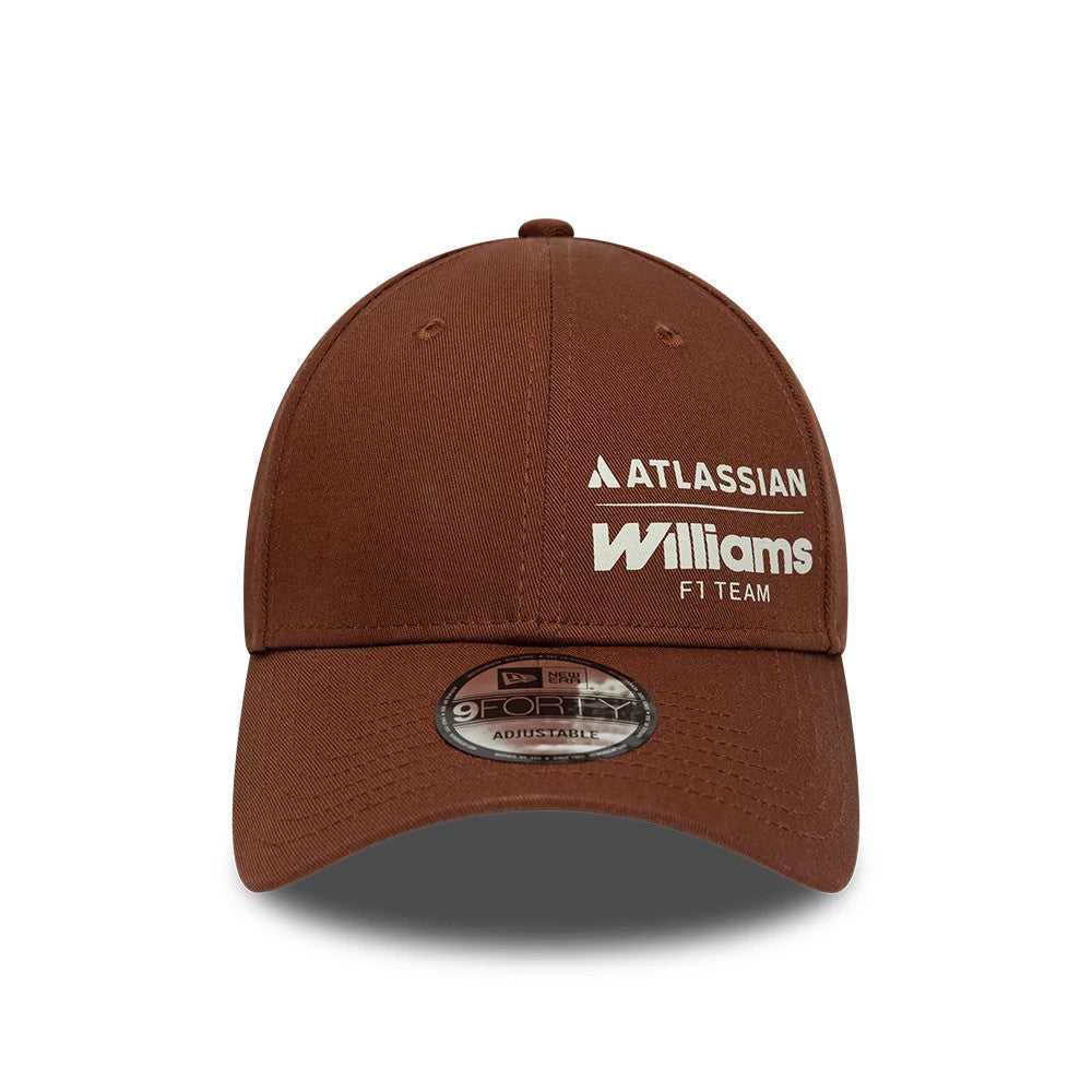 Williams Brown New Era 9FORTY Adjustable Cap, front view showing white embroidered Atlassian and Williams F1 Team logos on the brown front panel, with a curved brown visor featuring a 9FORTY size sticker, and matching eyelets and top button.