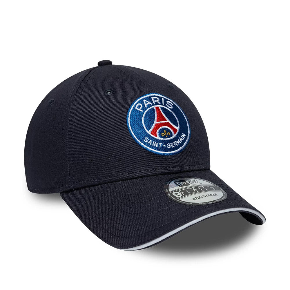 Paris Saint-Germain Core Navy New Era 9FORTY Adjustable Cap, three-quarter view showing a raised embroidered Paris Saint-Germain crest on the front panel, with a curved visor featuring a contrasting white rim and a 9FORTY size sticker on top.