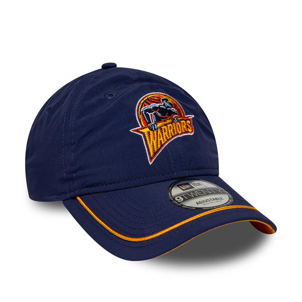 Warriors NBA Hardwood Classic Nylon Dark Blue New Era 9TWENTY Adjustable Cap, front view showing a embroidered Warriors logo on the structured dark blue crown, a curved visor with yellow piping detail, and a silver 9TWENTY size sticker.
