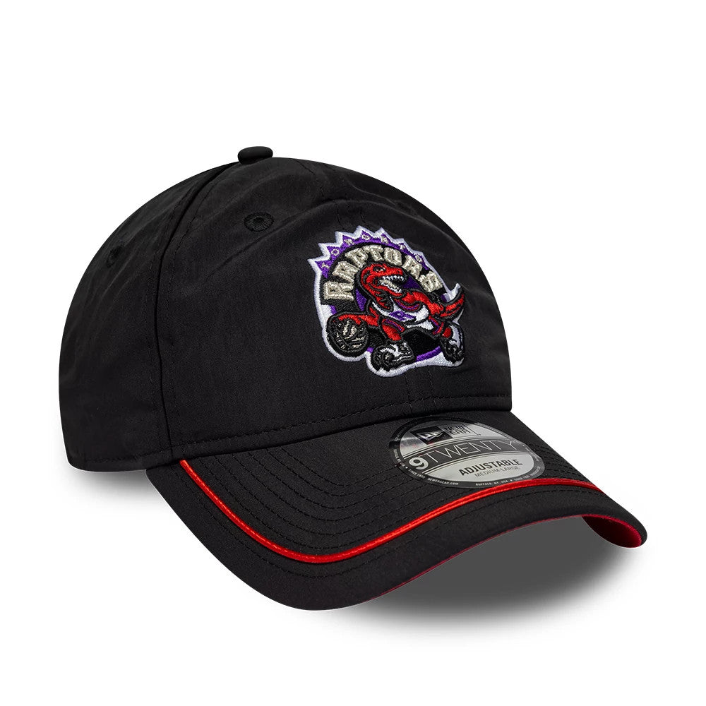 Toronto Raptors NBA Hardwood Classic Nylon Black New Era 9TWENTY Adjustable Cap, front view showing the embroidered red and purple Raptors logo on the structured black crown, with a black curved visor featuring a red stripe.