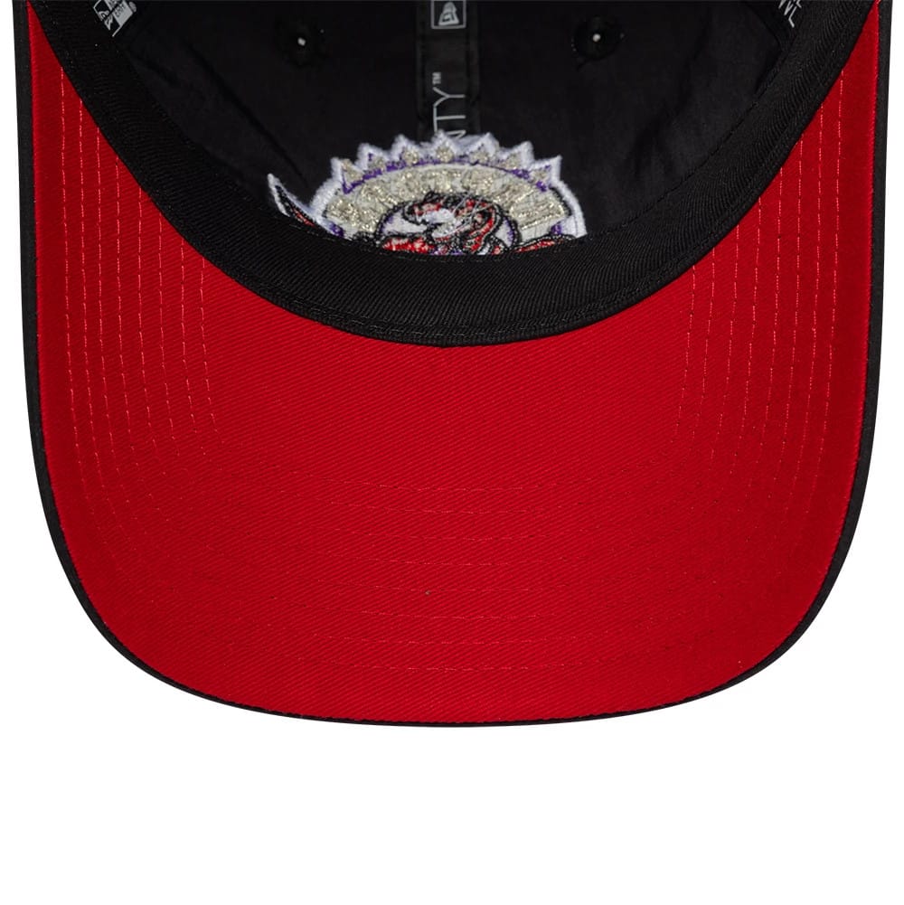 Toronto Raptors NBA Hardwood Classic Nylon Black New Era 9TWENTY Adjustable Cap, inside view showing a red undervisor contrasted with the black sweatband, detailed with interior black taping and the underside of the embroidered front logo.