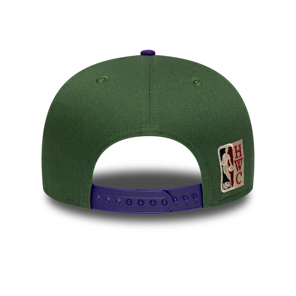 Bucks NBA Hardwood Classic Dark Green New Era 9FIFTY Snapback Adjustable Cap, rear view showing the NBA HWC logo embroidered on the right side, green structured crown, and a dark purple adjustable snap closure.
