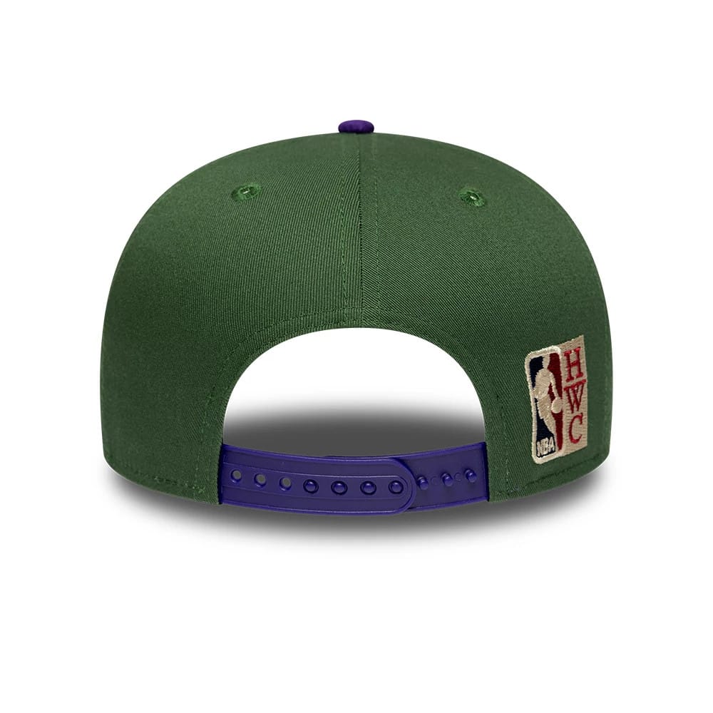 Bucks NBA Hardwood Classic Dark Green New Era 9FIFTY Snapback Adjustable Cap, rear view showing the NBA HWC logo embroidered on the right side, green structured crown, and a dark purple adjustable snap closure.