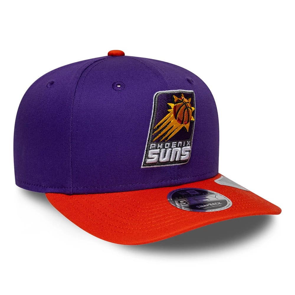 Phoenix Suns NBA Hardwood Classic Purple New Era 9FIFTY Snapback Adjustable Cap, three-quarter view showing the orange and yellow embroidered basketball logo on the front panel, bright orange flat visor, and 9FIFTY size sticker on the visor.