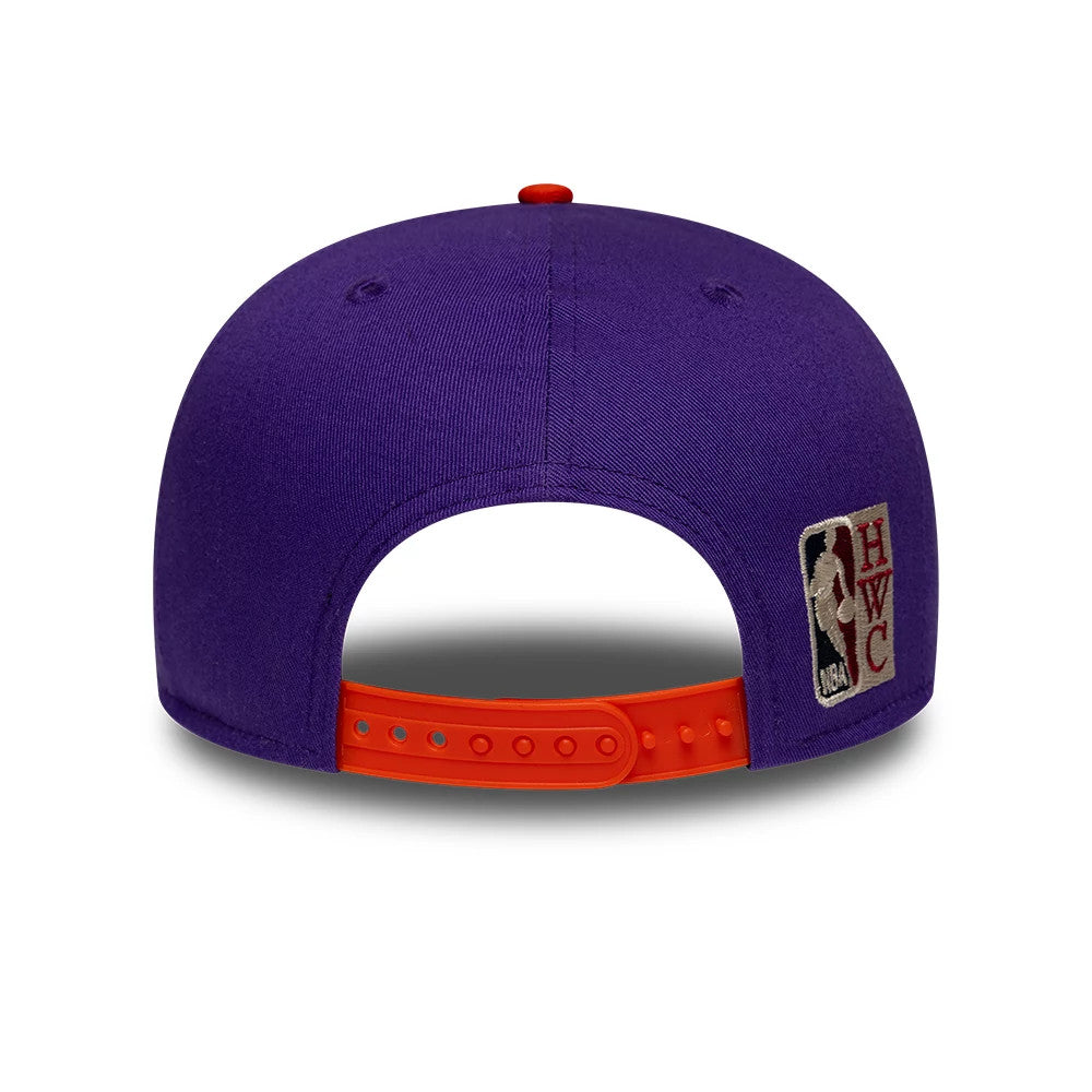 Phoenix Suns NBA Hardwood Classic Purple New Era 9FIFTY Snapback Adjustable Cap, rear view showing the embroidered HWC logo on the right side, an adjustable orange snapback strap, and the top button matching the purple crown.