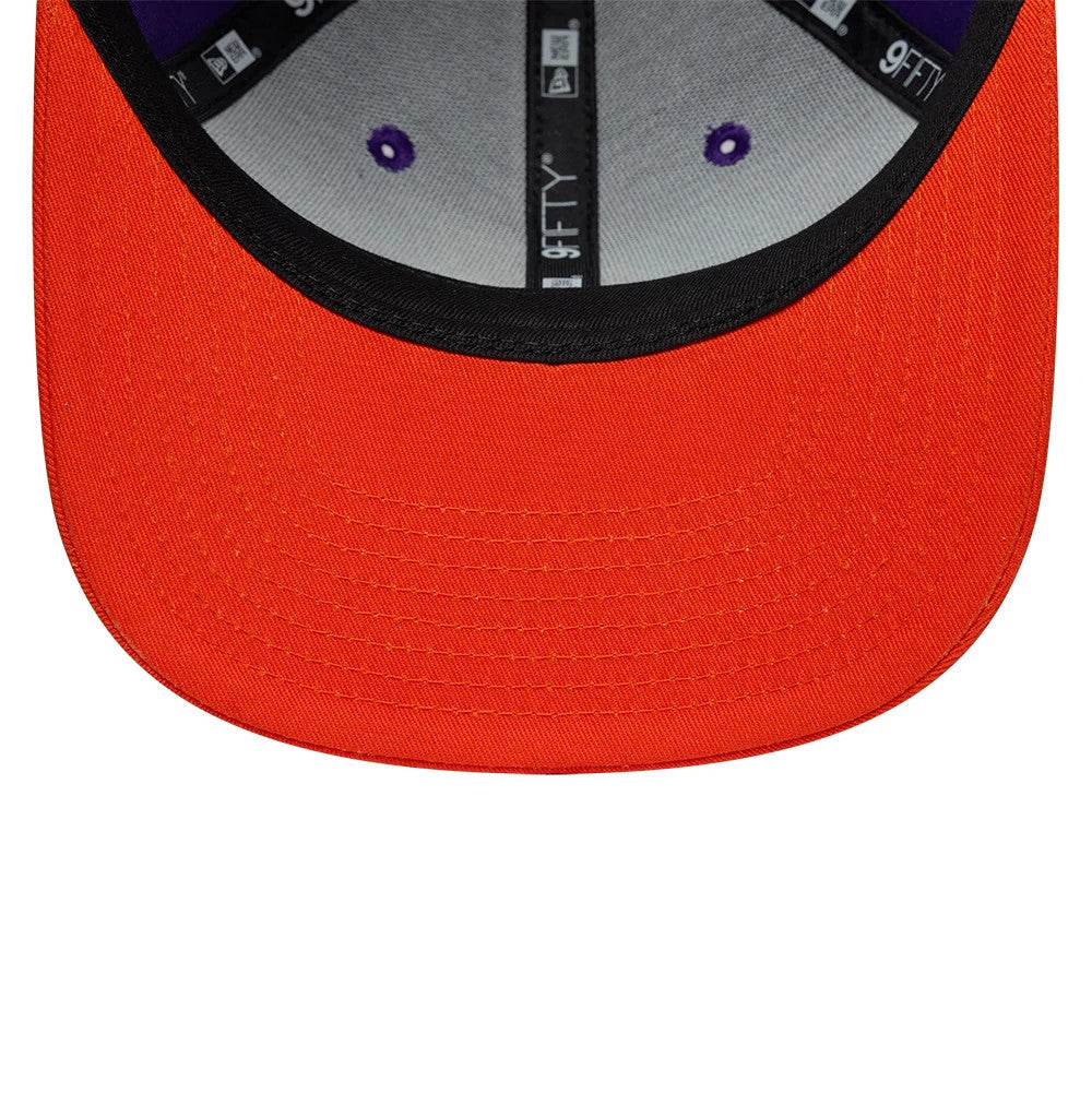 Phoenix Suns NBA Hardwood Classic Purple New Era 9FIFTY Snapback Adjustable Cap, inside view showing grey sweatband with black taping featuring New Era and 9FIFTY logos, and a bright orange undervisor with a black edge.