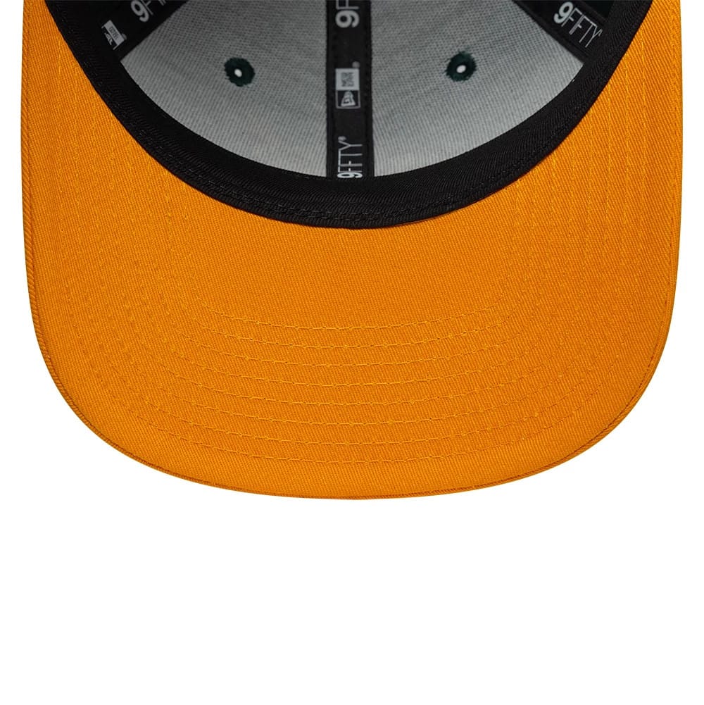 Supersonics NBA Hardwood Classic Green New Era 9FIFTY Snapback Adjustable Cap, inside view showing a contrasting black sweatband, grey undervisor with a yellow lower section, black and white branded taping, and six green eyelet stitches.