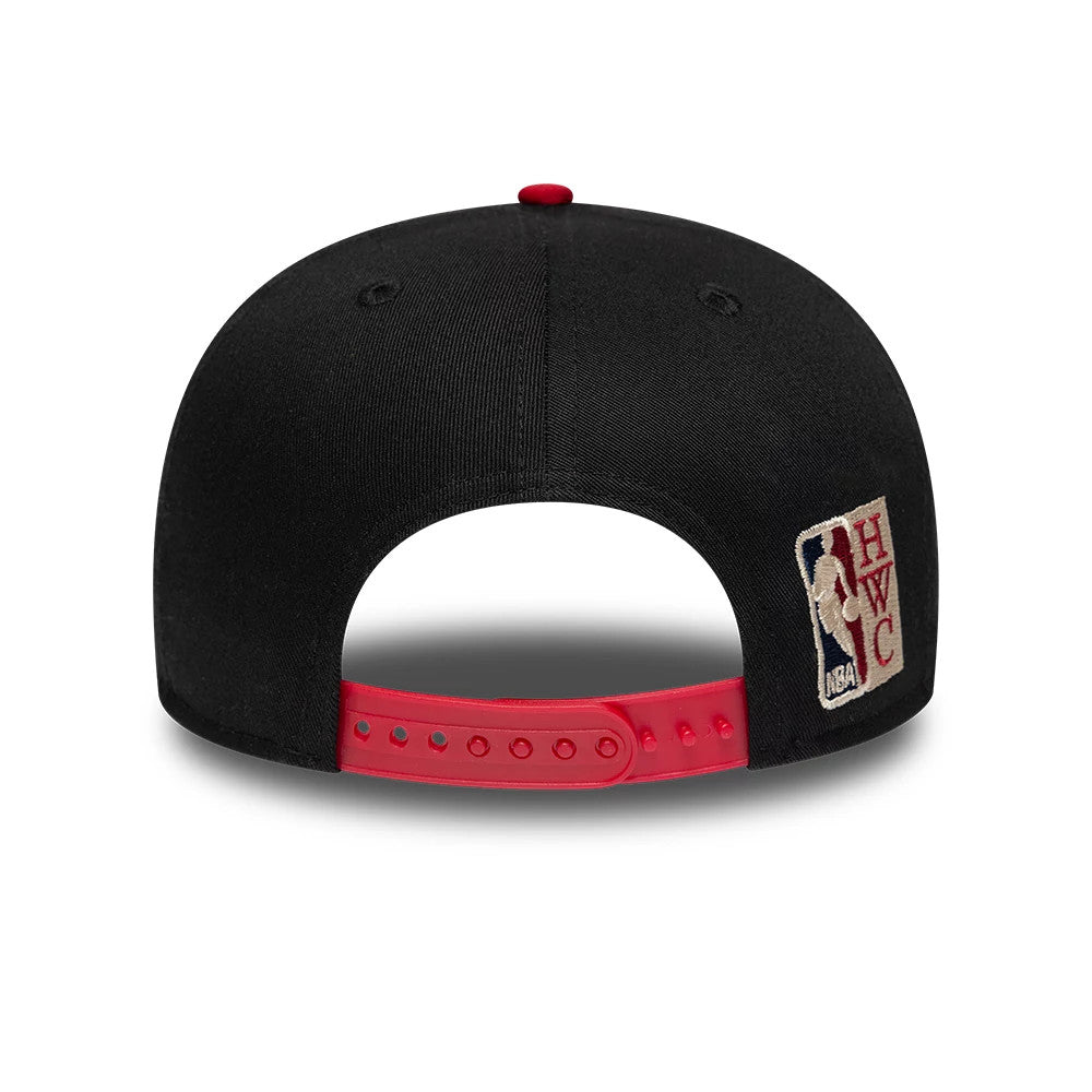 Miami Heat NBA Hardwood Classic Black New Era 9FIFTY Snapback Adjustable Cap, rear view showing the Heritage NBA logo patch on the right side of the back panels, red adjustable snap closure, and black structured crown with a red top button.