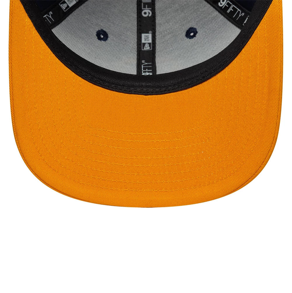 Warriors NBA Hardwood Classic Dark Blue New Era 9FIFTY Snapback Adjustable Cap, inside view showing the orange undervisor, black sweatband with logos, and grey crown lining with two embroidered navy eyelets and white New Era taping.