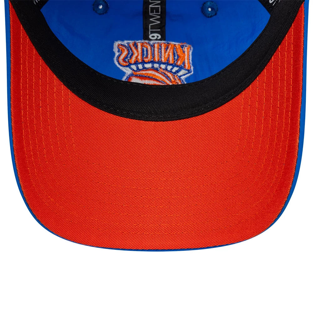 New York Knicks NBA Hardwood Classic Nylon Blue New Era 9TWENTY Adjustable Cap, inside view showing orange undervisor, black sweatband with 9TWENTY branding, and blue fabric with New York Knicks logo stitching on the crown.