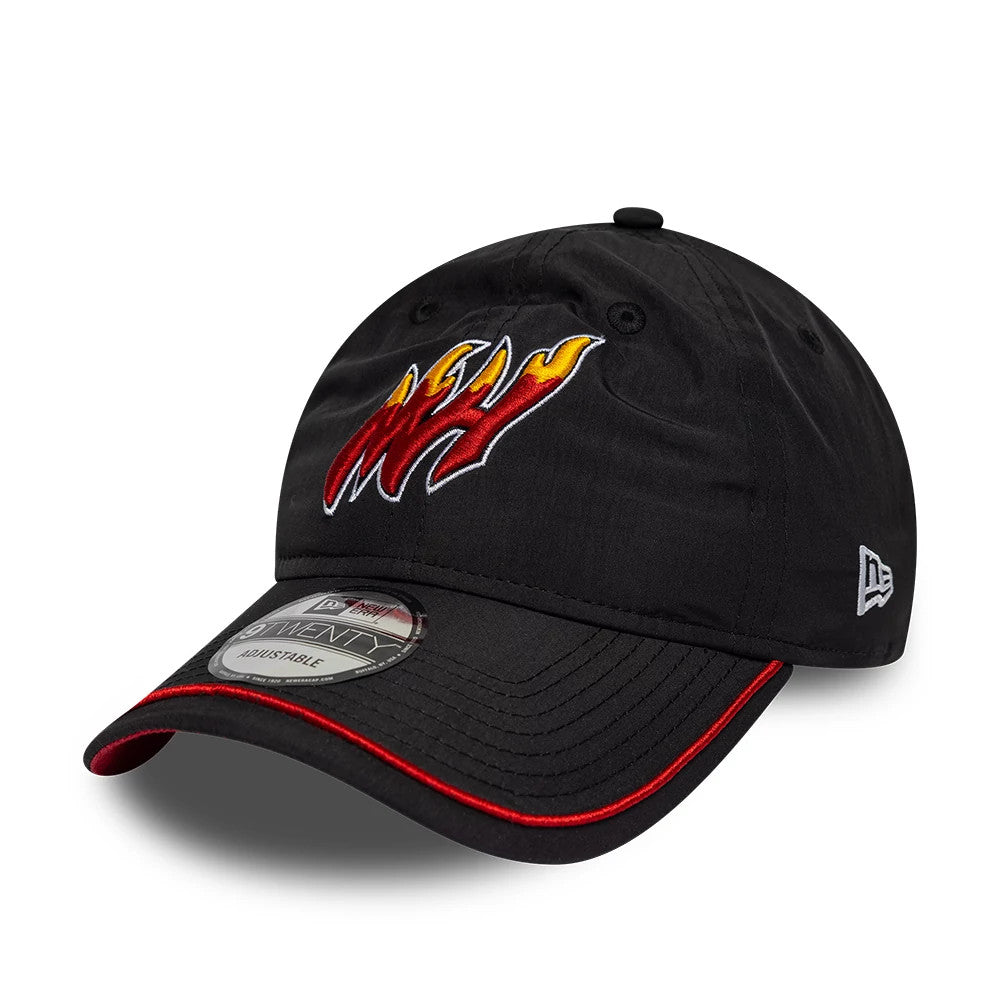 Miami Heat NBA Hardwood Classic Nylon Black New Era 9TWENTY Adjustable Cap, three-quarter view showing flame-themed embroidered Heat logo on the front panel, contrasting red detail on the black curved visor, and New Era flag logo on the left side.