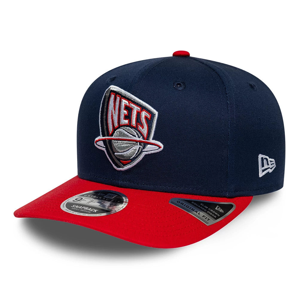 Nets NBA Hardwood Classic Dark Blue New Era 9FIFTY Snapback Adjustable Cap, front view showing the raised embroidered Nets logo featuring a basketball and ring on the dark blue crown, with a contrasting bright red visor and 9FIFTY size sticker.
